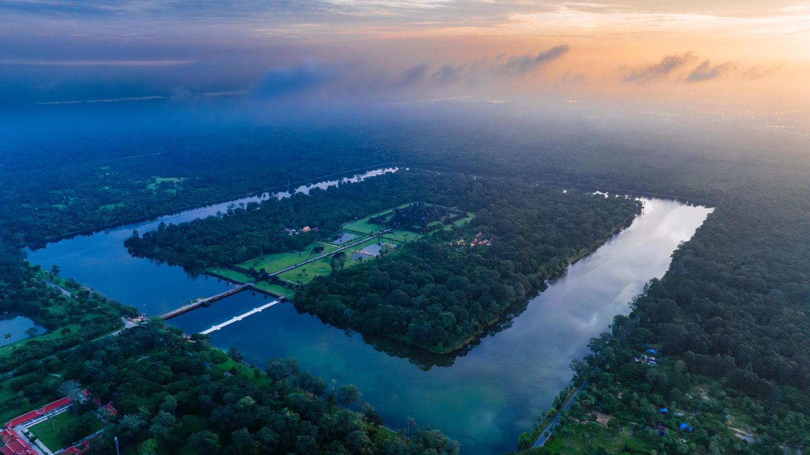 Illustrative aerial view of a calm river and green landscape near Siem Reap at sunrise