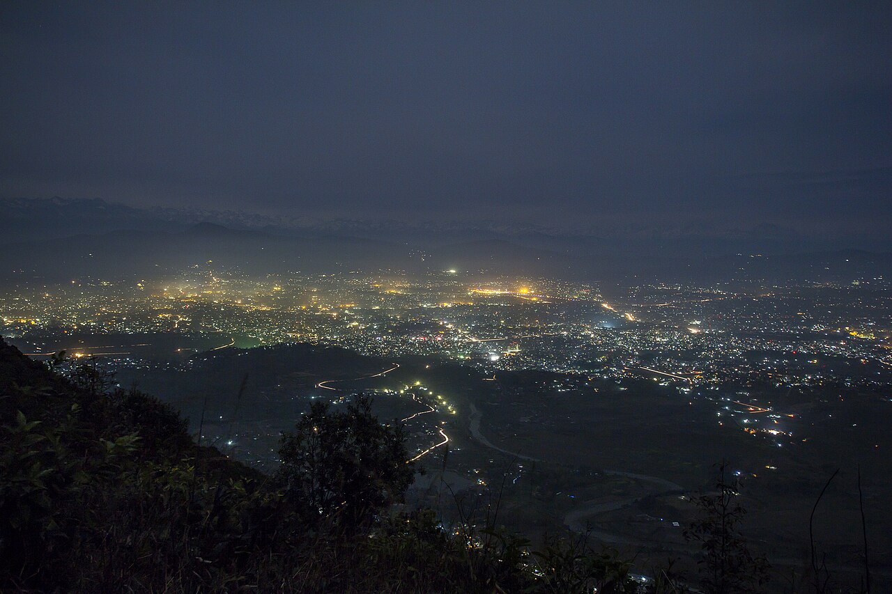 Kathmandu city lights seen from the surrounding hills at night.