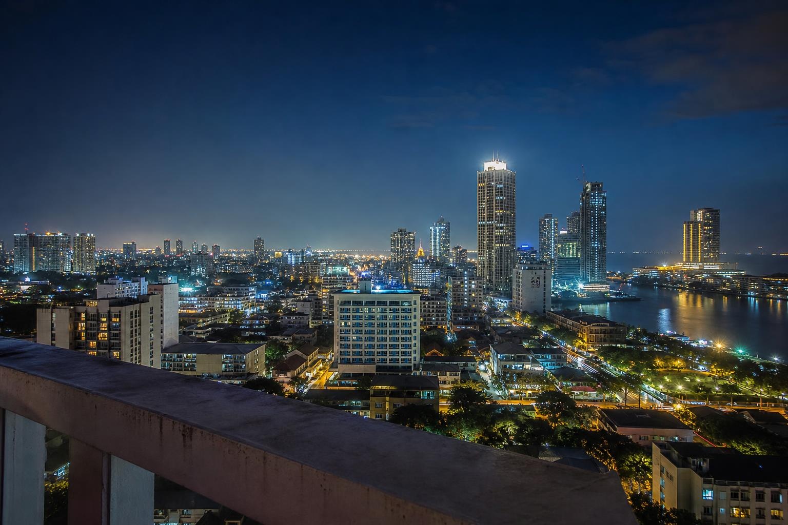 Illustrative night skyline of Colombo viewed from a rooftop.