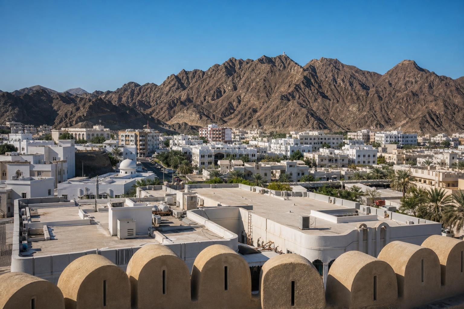 Illustrative view of Muscat's white low-rise buildings beneath rugged mountains.